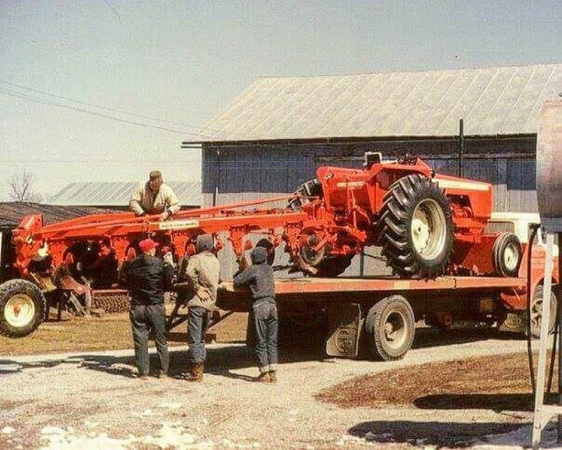 A unique pic of Allis Chalmers tractor and plow being delivered.